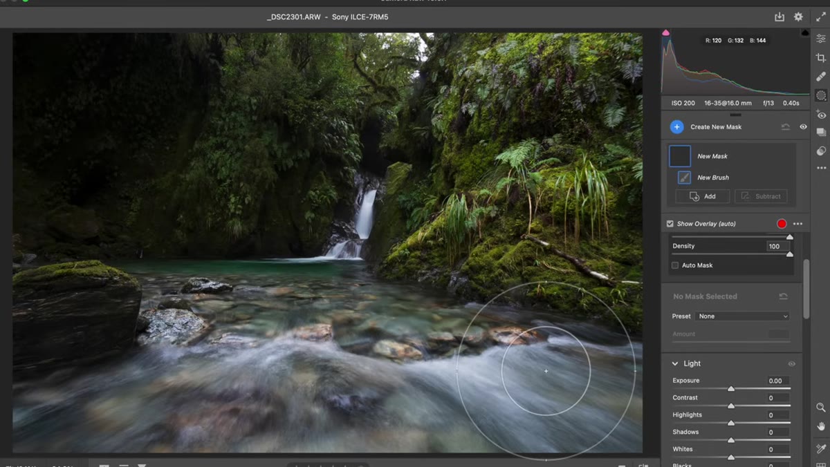 Adjustment brush being painted over foreground with exposure pulled down