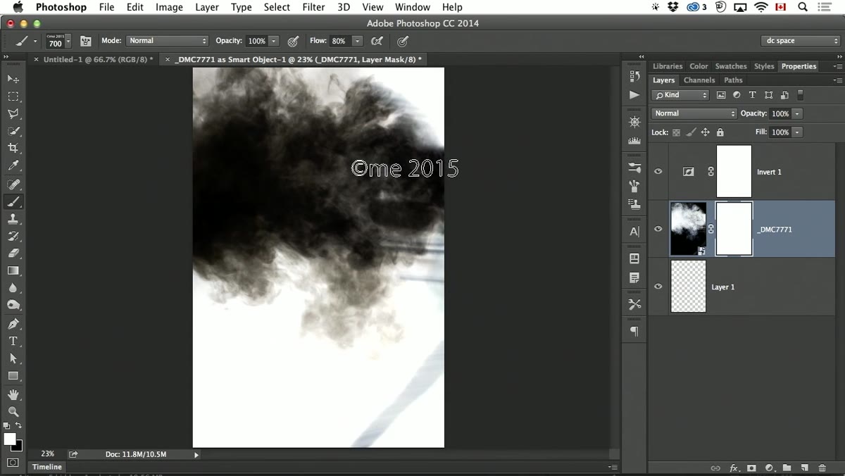 Layer mask being painted with soft brush to fade smoke edges
