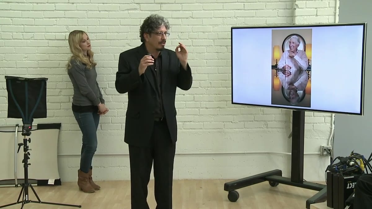 Photographer adjusting exposure during live interview shoot