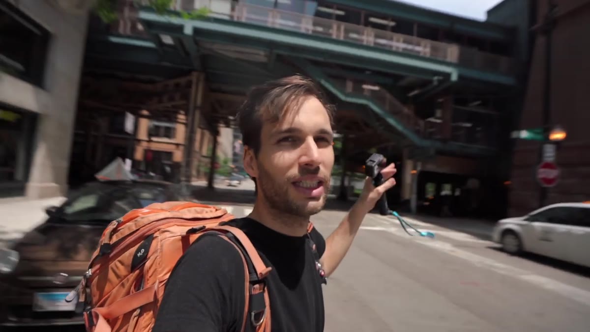 Camera positioned low, shooting from the middle of a road toward buildings