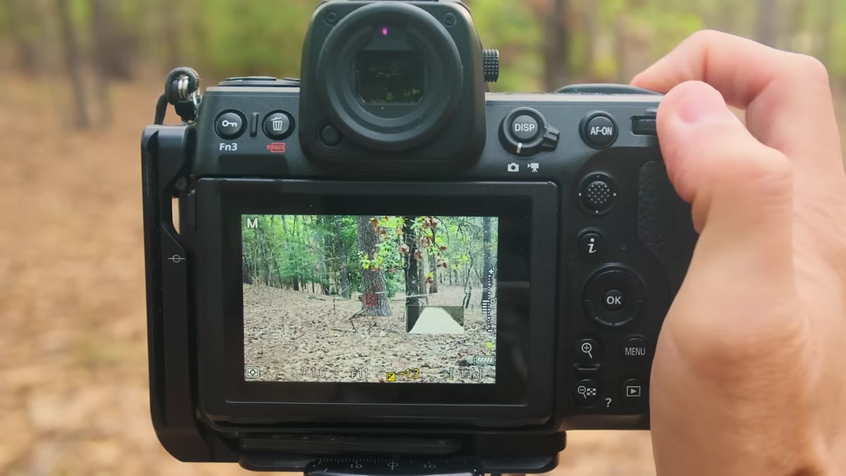 Photographer turning exposure compensation dial, exposure changing in real time