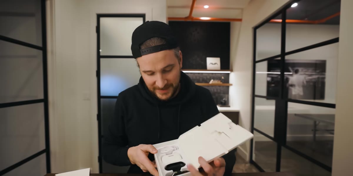 McKinnon opens the new charging case showing the built-in screen